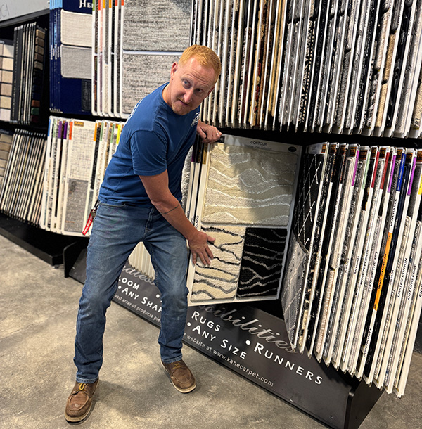 Dave Sonner showing carpet options in Castle Rock showroom